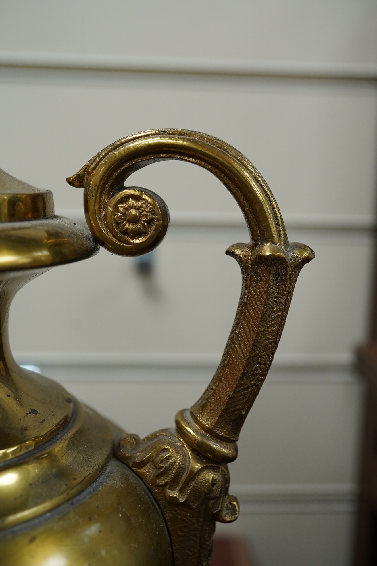 A pair of Empire style brass lamps with twin handles and applied decoration, 36cm high including the fitting. Condition - fair to good, untested